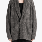 Grey knitwear worn by a person, showing the knitwear fit