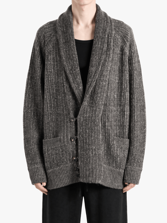Grey knitwear worn by a person, showing the knitwear fit