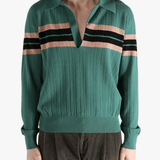 Green knitwear worn by a person, showing the knitwear's fit