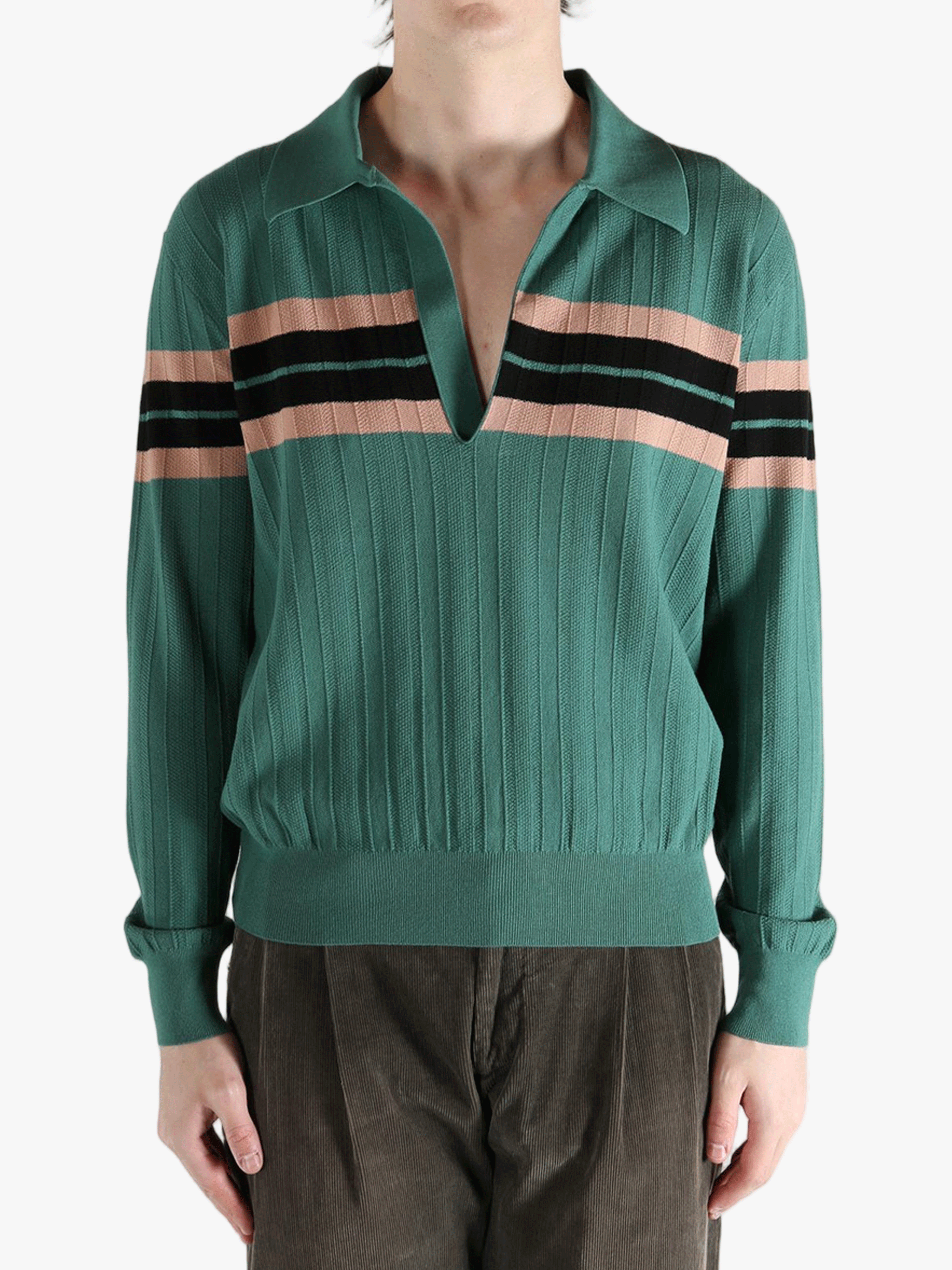 Green knitwear worn by a person, showing the knitwear's fit