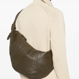 Green bag worn by a person, showing the bag fit