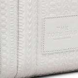 Close up of the white bag, showing texture of the leather fabric
