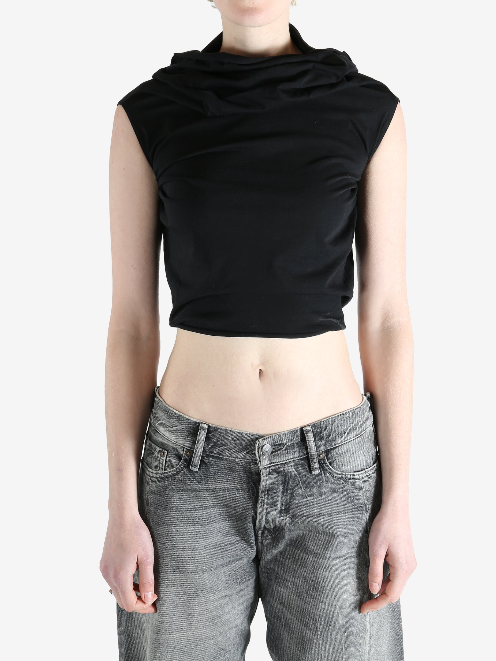 black sleeveless top worn by a person, showing the top fit