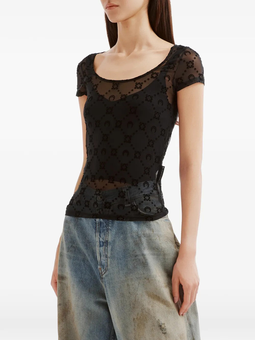 Black top worn by a person, showing the top fit