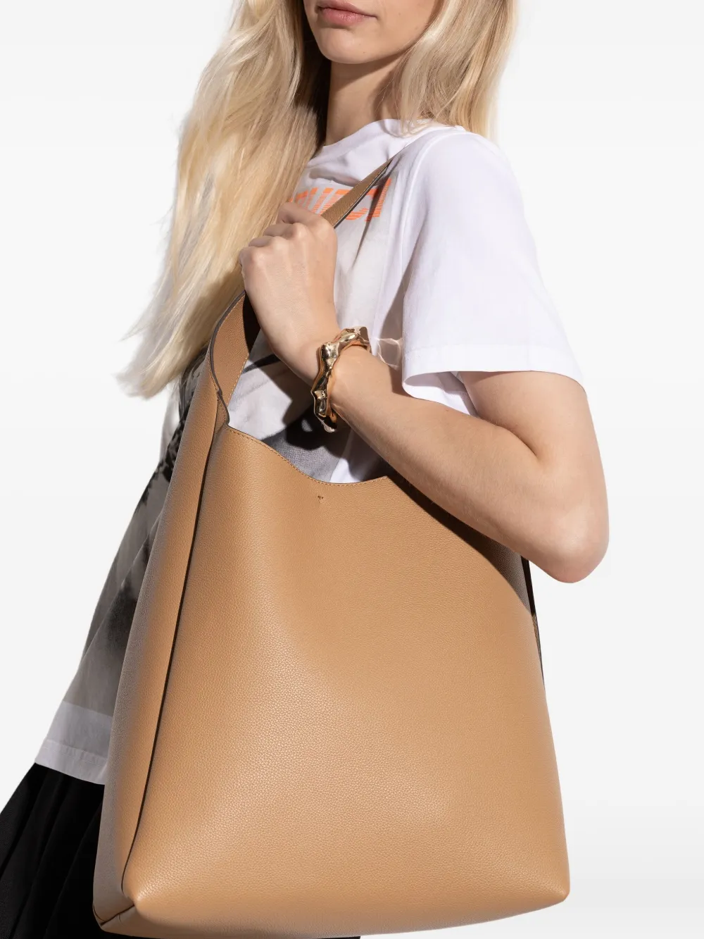 Tan bag worn by a person, showing the bag fit