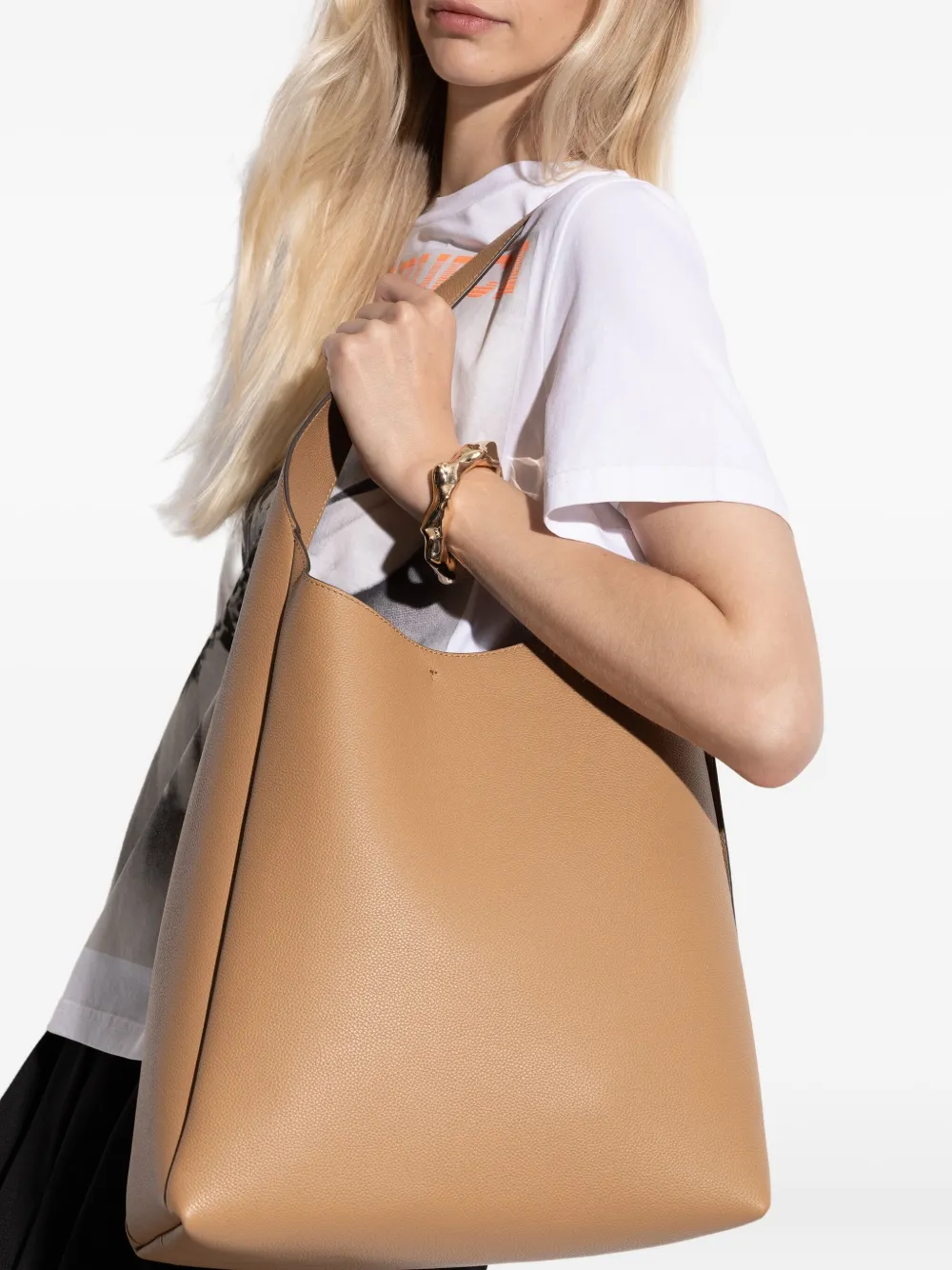 Tan bag worn by a person, showing the bag fit