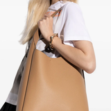 Tan bag worn by a person, showing the bag fit
