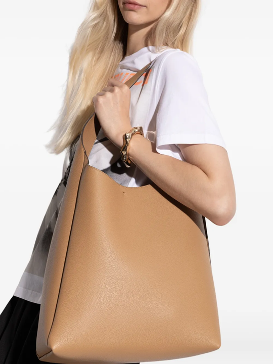 Tan bag worn by a person, showing the bag fit
