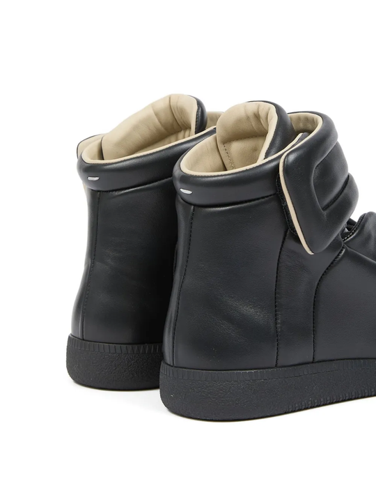Close up of the black sneakers, showing texture of the calf leather 