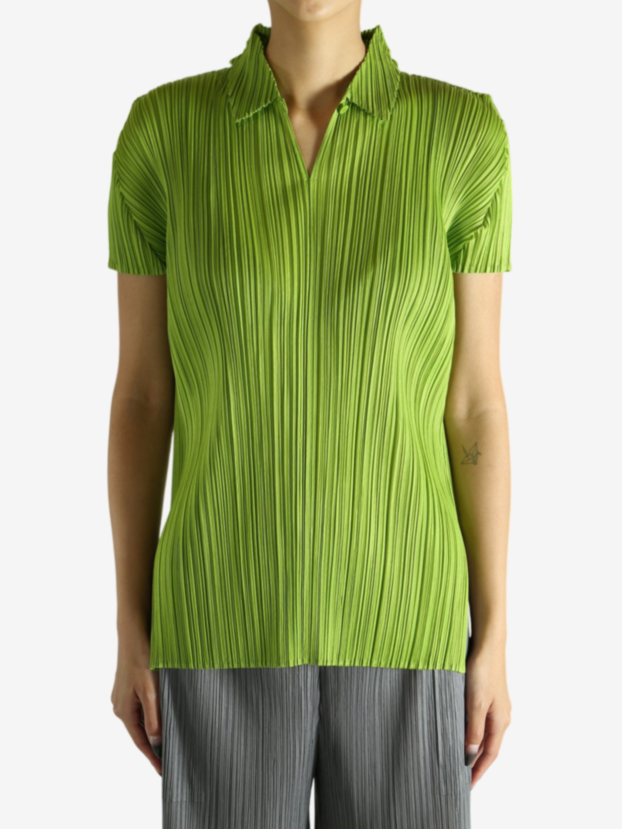Green shirt worn by a person, showing the shirt's fit