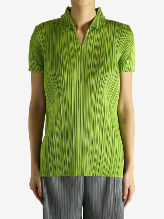 Green shirt worn by a person, showing the shirt's fit