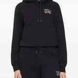 Black hoodie worn by a person, showing the hoodie's fit