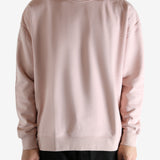 Pink sweatshirt worn by a person, showing the sweatshirt's fit
