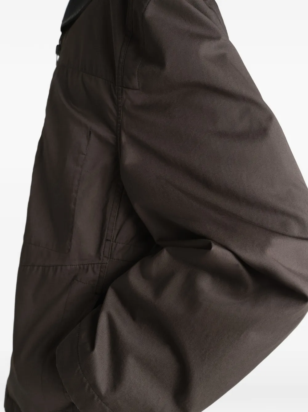 Brown jacket worn by a person, showing the jacket fit