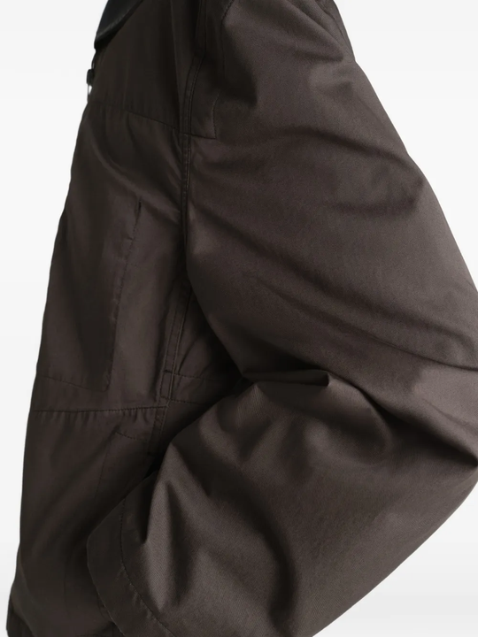 Brown jacket worn by a person, showing the jacket fit