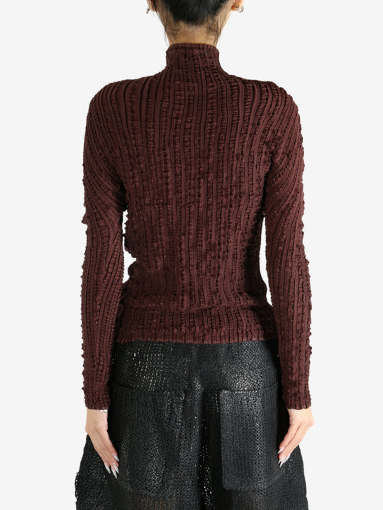 Brown shirt worn by a person, showing the shirt's fit