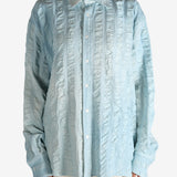 Blue shirt worn by a person, showing the shirt's fit