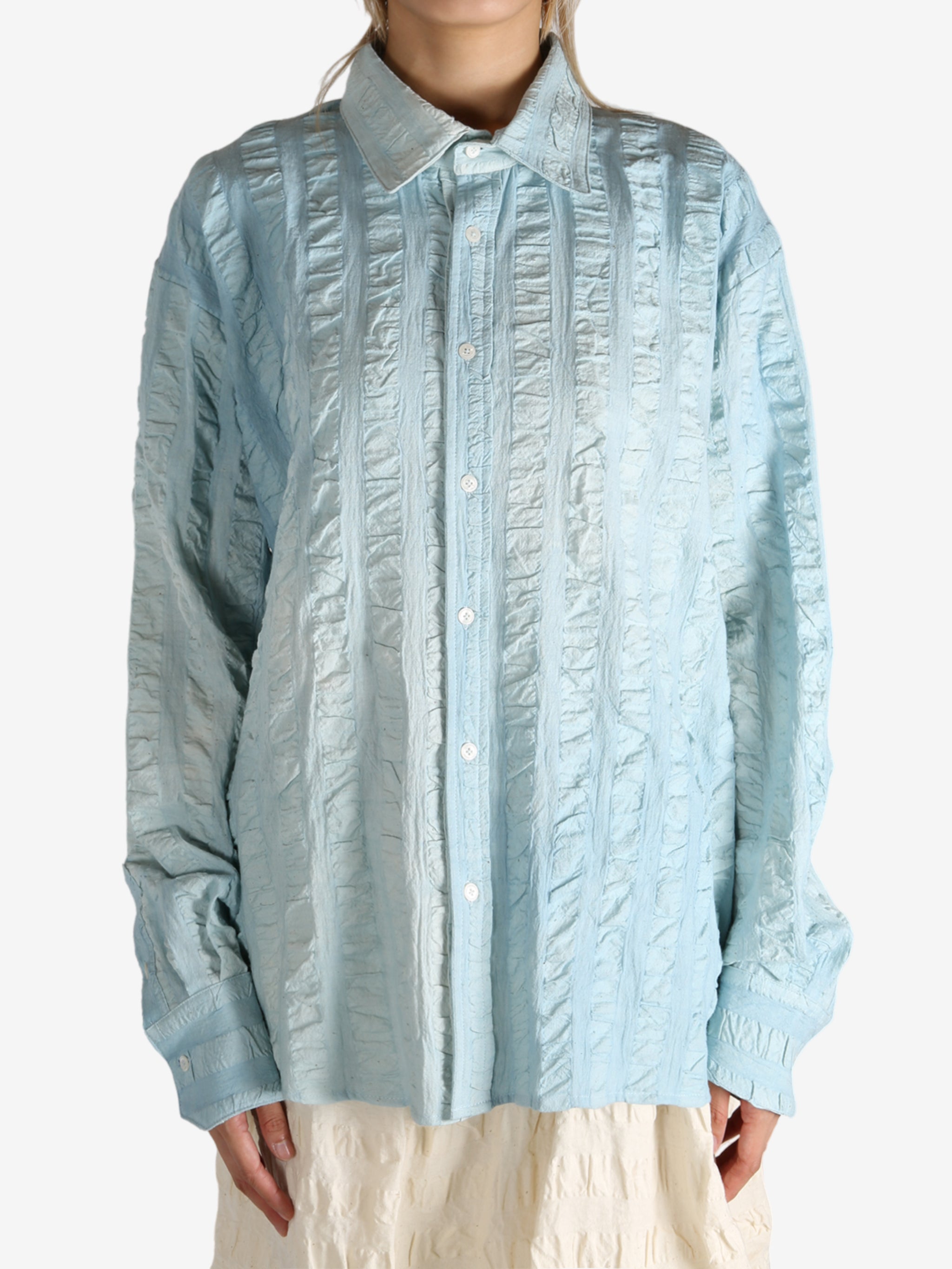 Blue shirt worn by a person, showing the shirt's fit