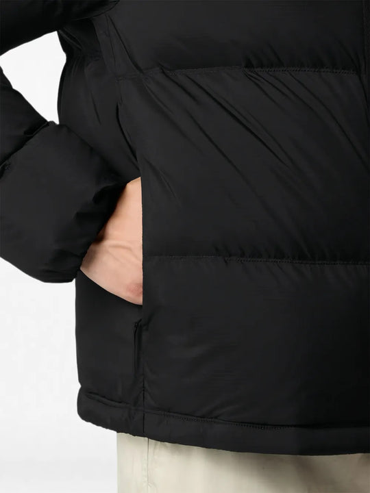 Black jacket worn by a person, showing the jacket fit