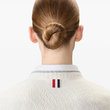 Close up of white knitwear, showing texture of the Wool fabric