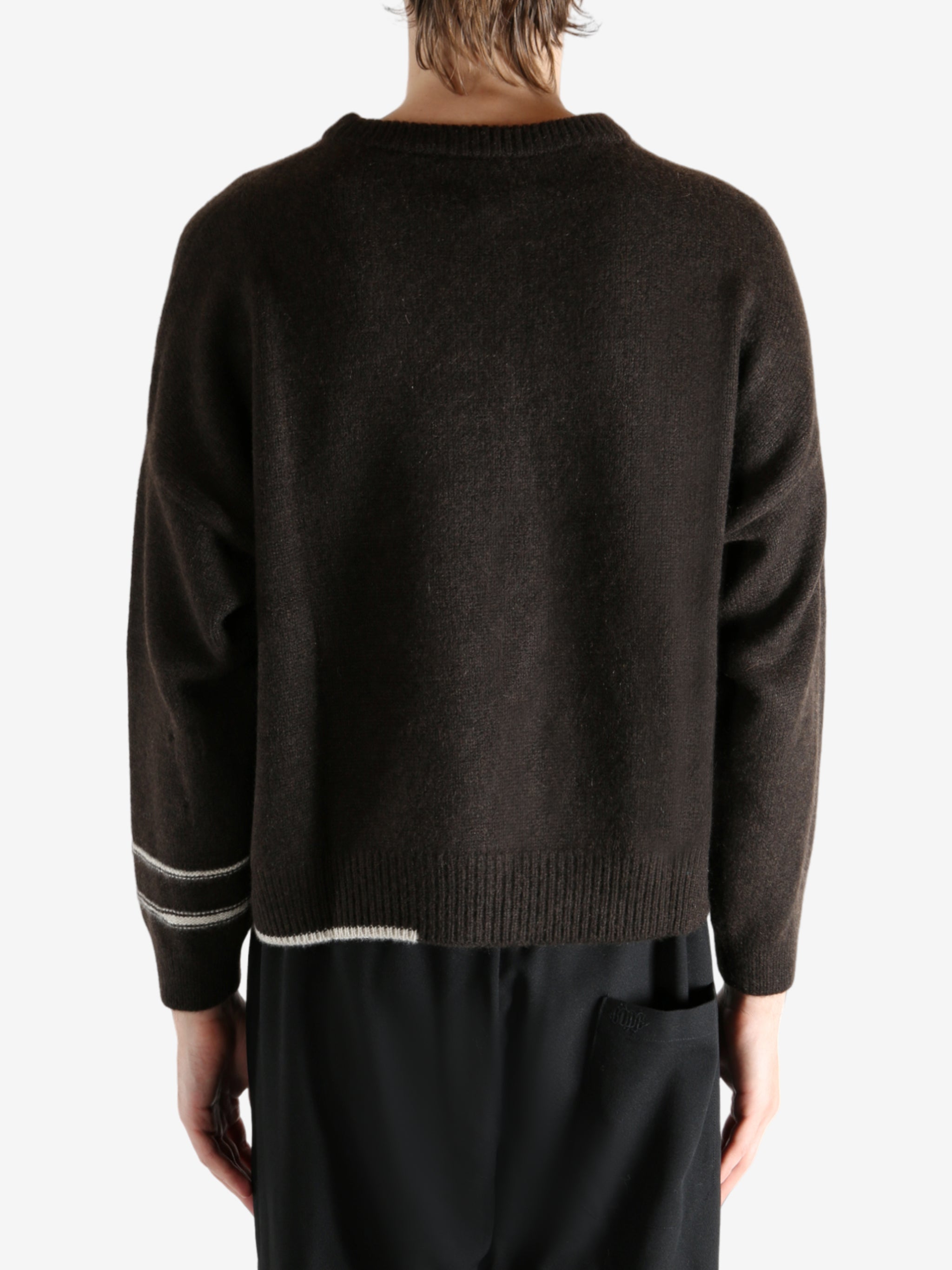 Black sweater worn by a person, showing the sweater's fit