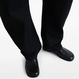 Black shoes worn by a person, showing the shoes fit