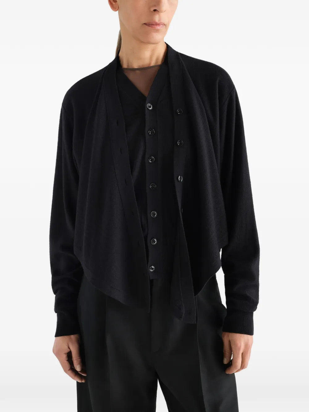 Black top worn by a person, showing the top fit