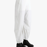 White pants worn by a person, showing the pants fit