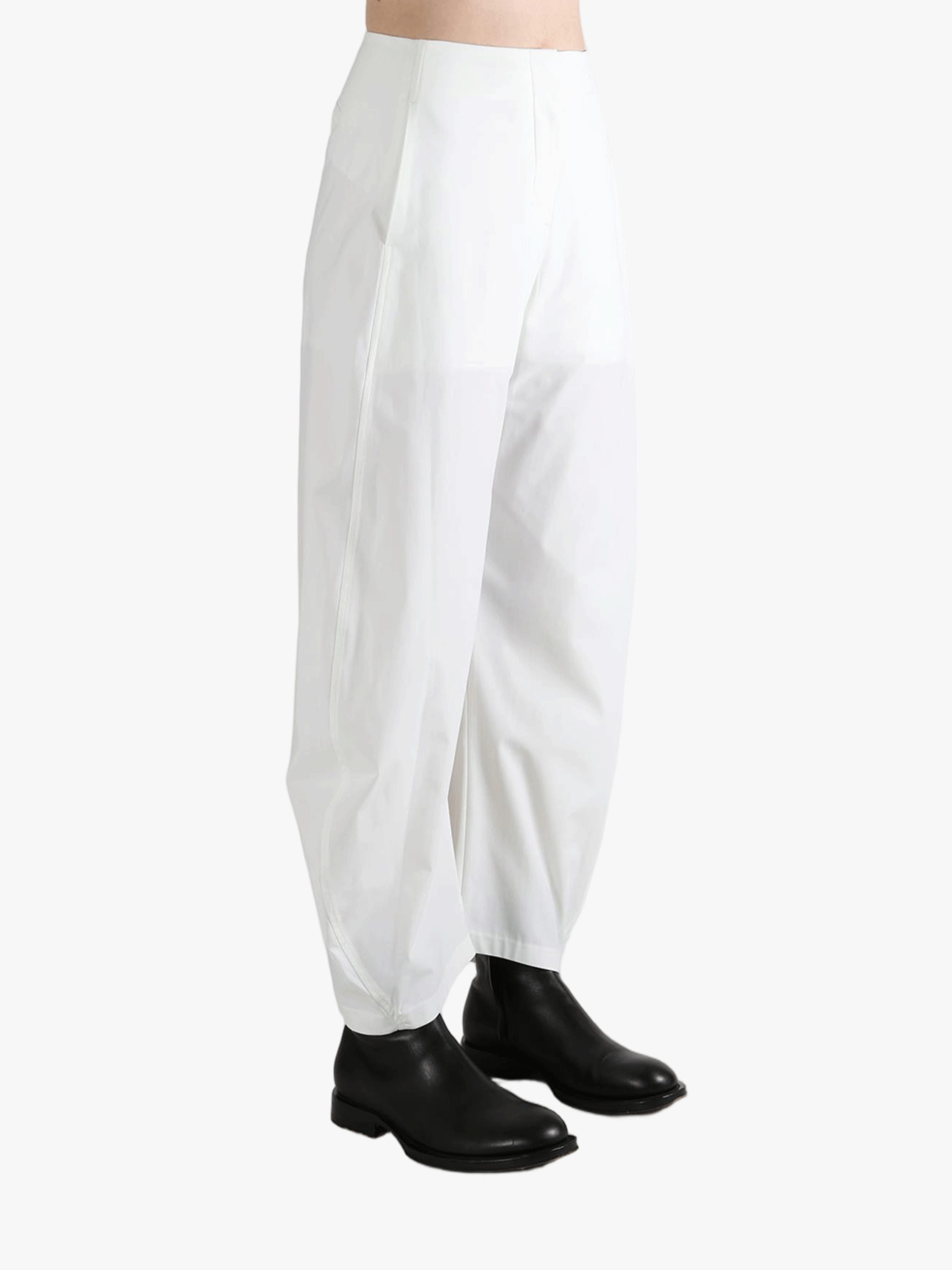 White pants worn by a person, showing the pants fit