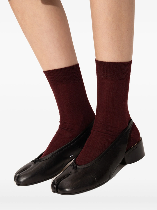 black heels worn by a person, showing the heels fit