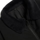 Close up of the black jacket, showing texture of the polyester fabric