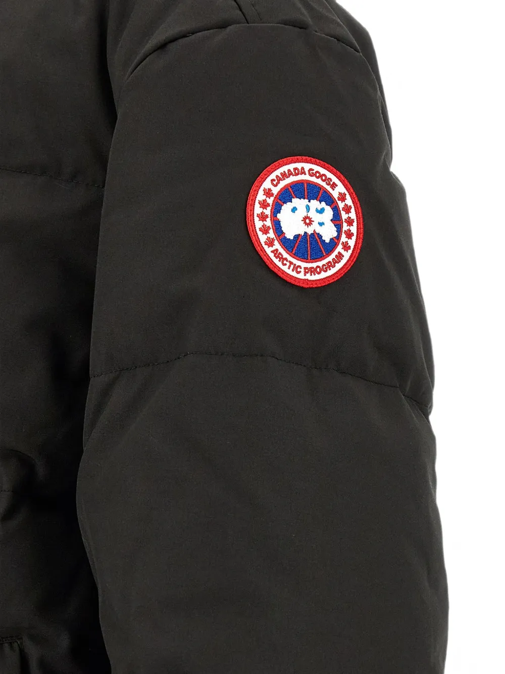 Close up of Black jacket, showing texture of the 84% recycled polyester/ 16% organic cotton made fabric