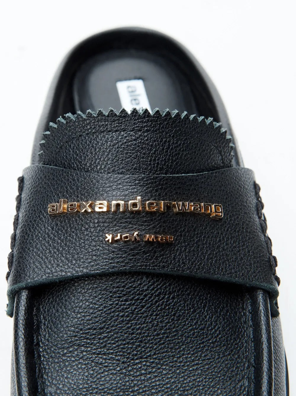 Close up of black Loafer, showing texture of the leather fabric