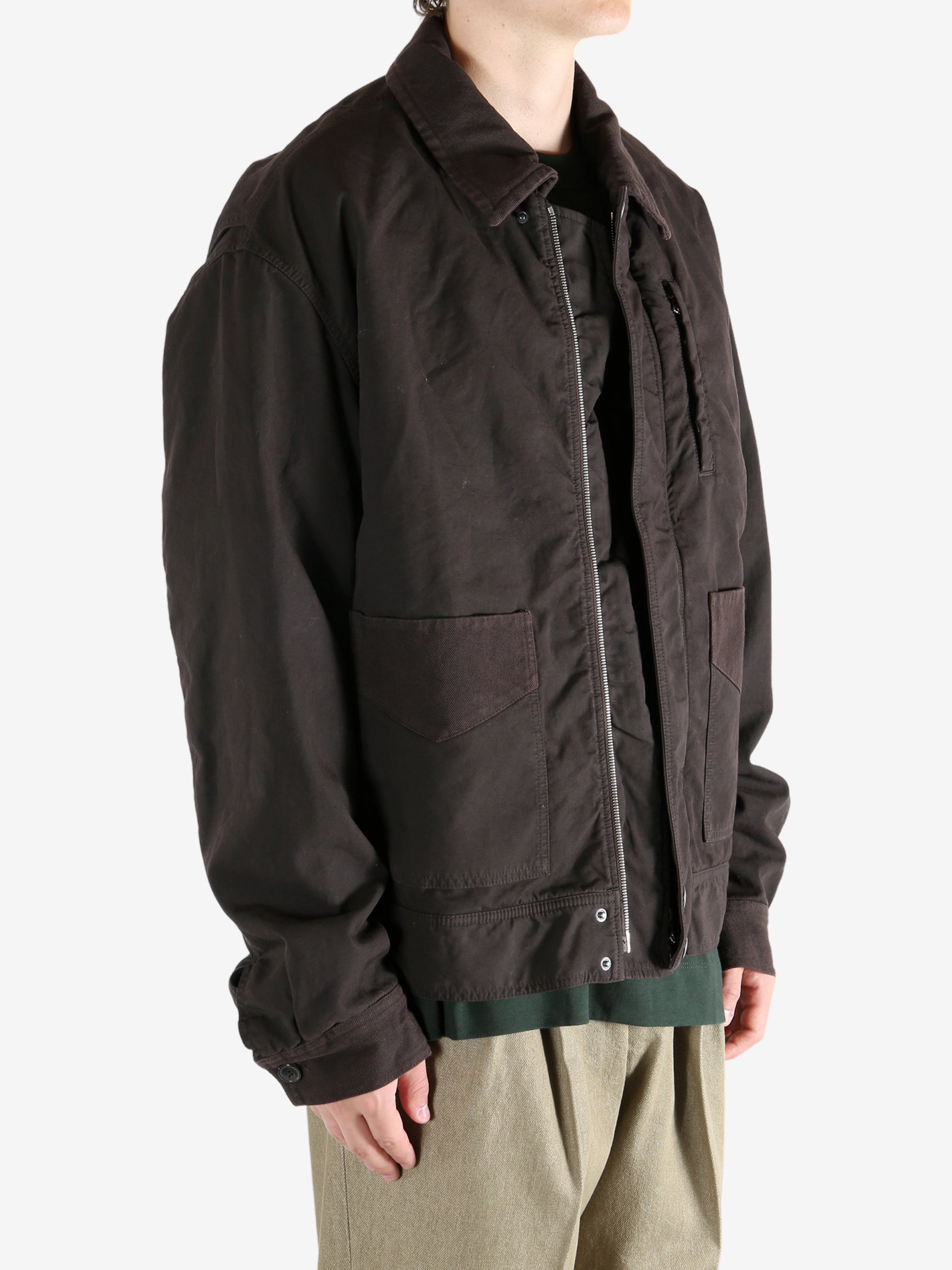 Brown jacket worn by a person, showing the jacket's fit