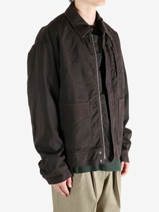 Brown jacket worn by a person, showing the jacket's fit