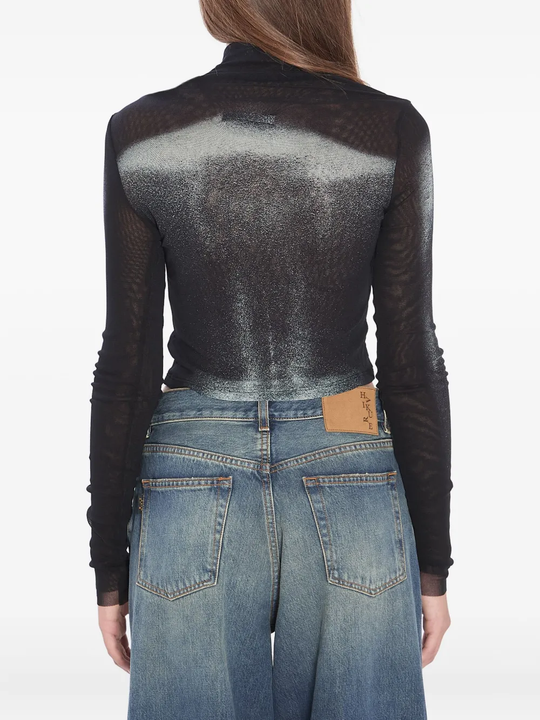 Black top worn by a person, showing the top's fit