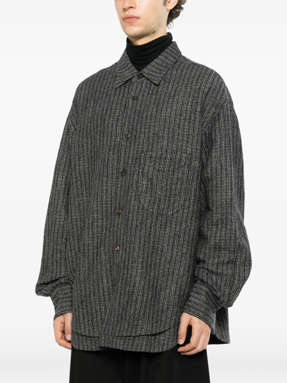 Grey shirt worn by a person, showing the shirt fit