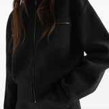 Black top worn by a person, showing the top fit
