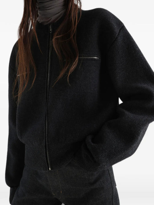 Black top worn by a person, showing the top fit