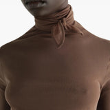 Brown top worn by a person, showing the top fit