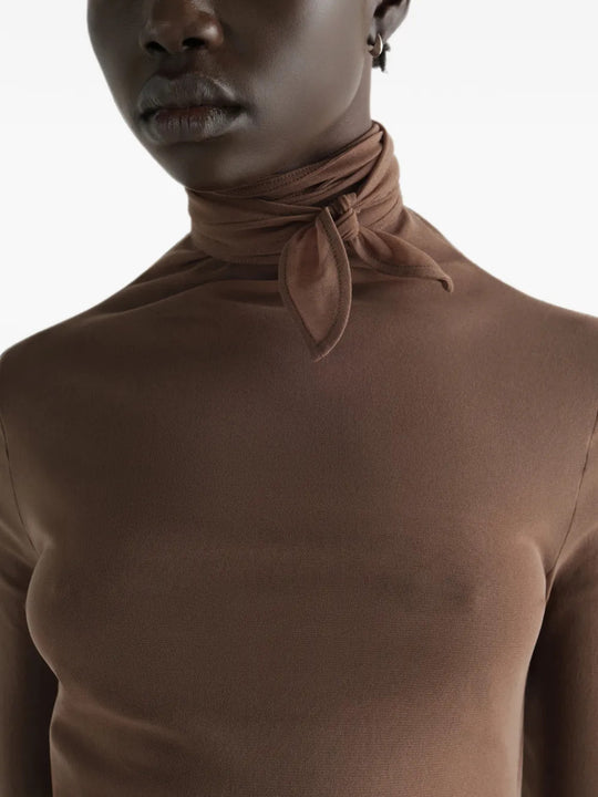 Brown top worn by a person, showing the top fit