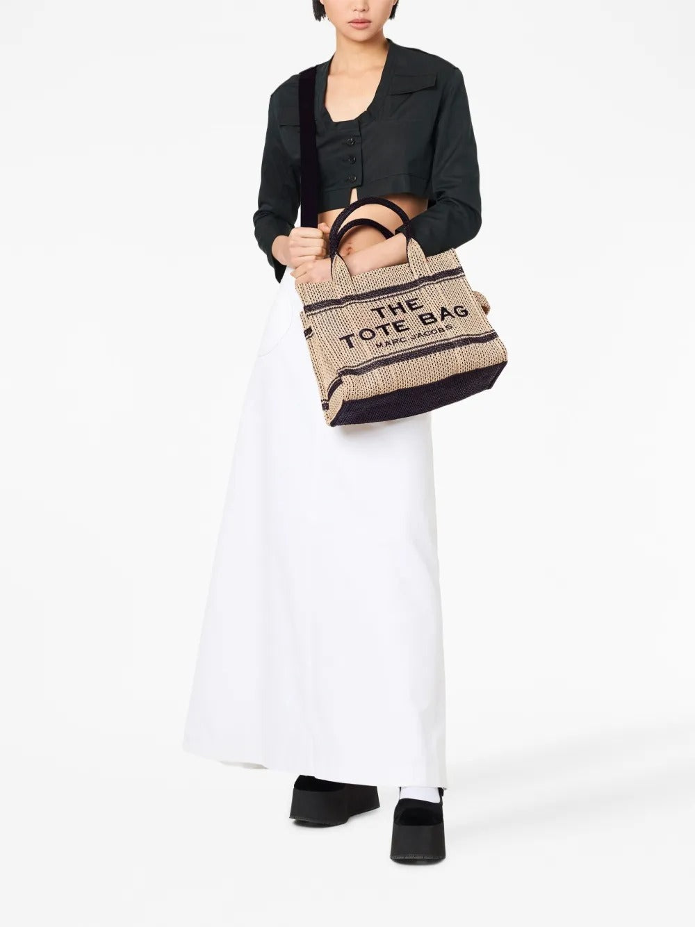 Tan bag carried by a person, showing the bag’s style