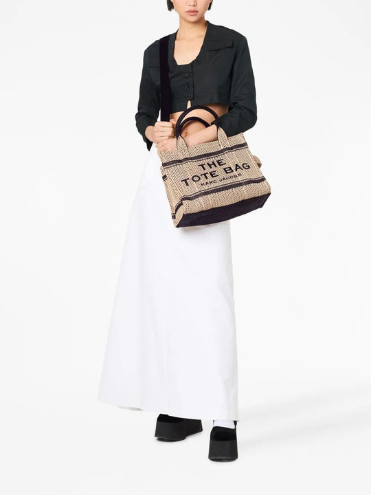 Tan bag carried by a person, showing the bag’s style