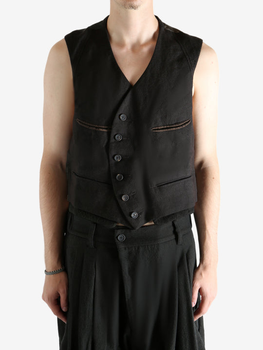 Grey vest worn by a person, showing the vest's fit