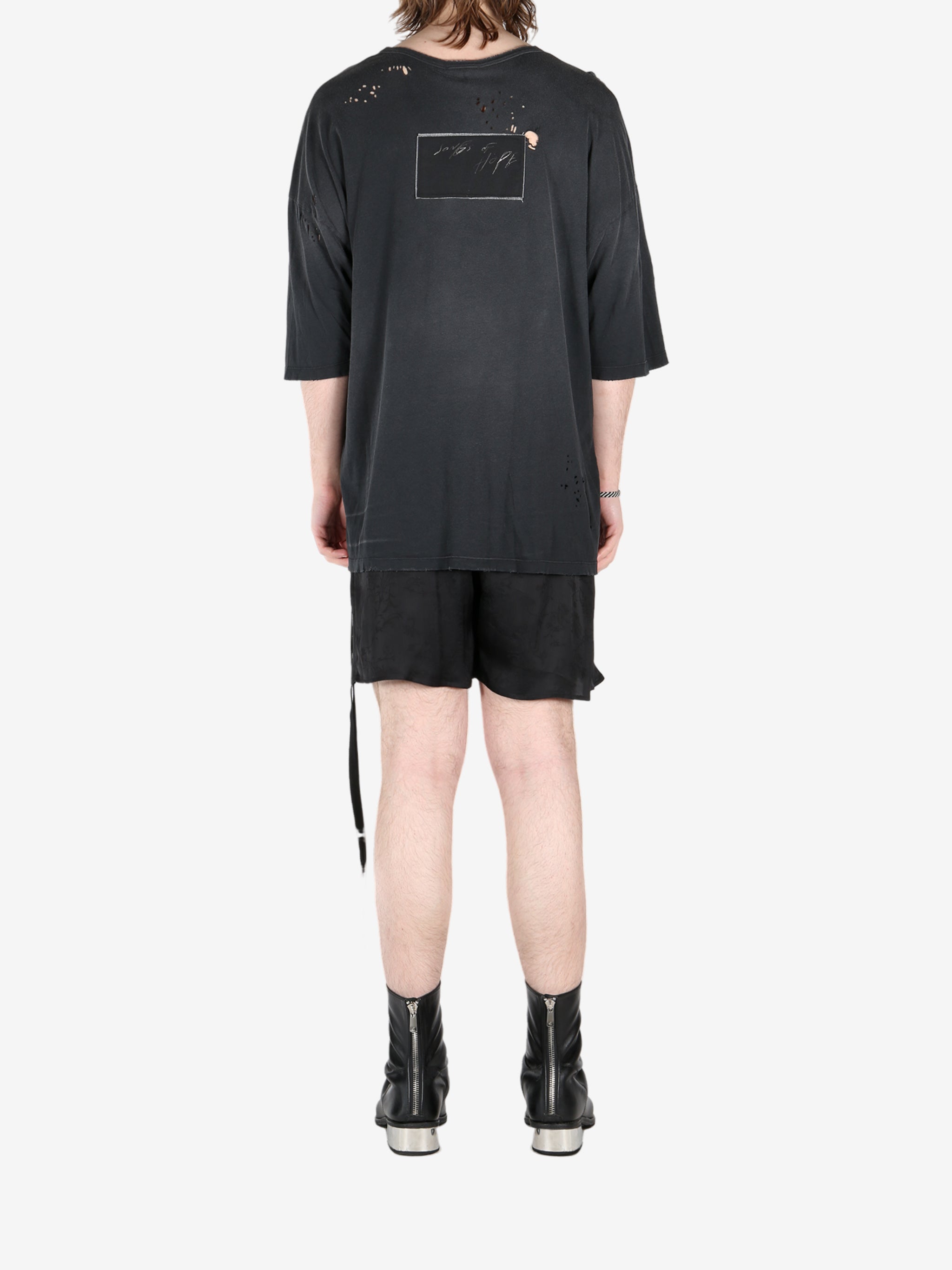 Black t-shirt, worn by a person, showing the t-shirt's fit