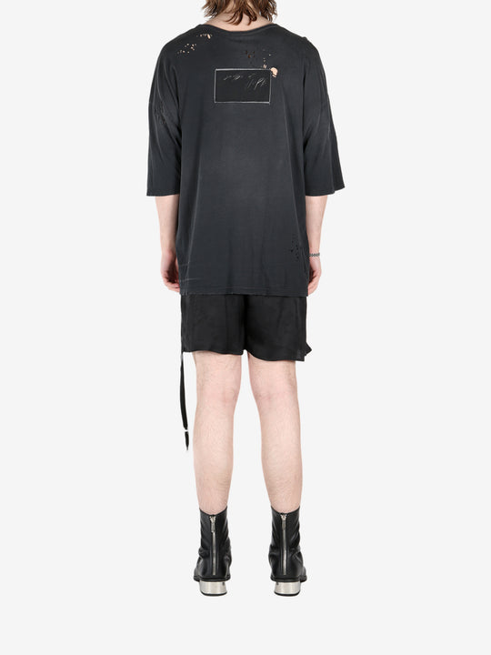 Black t-shirt, worn by a person, showing the t-shirt's fit