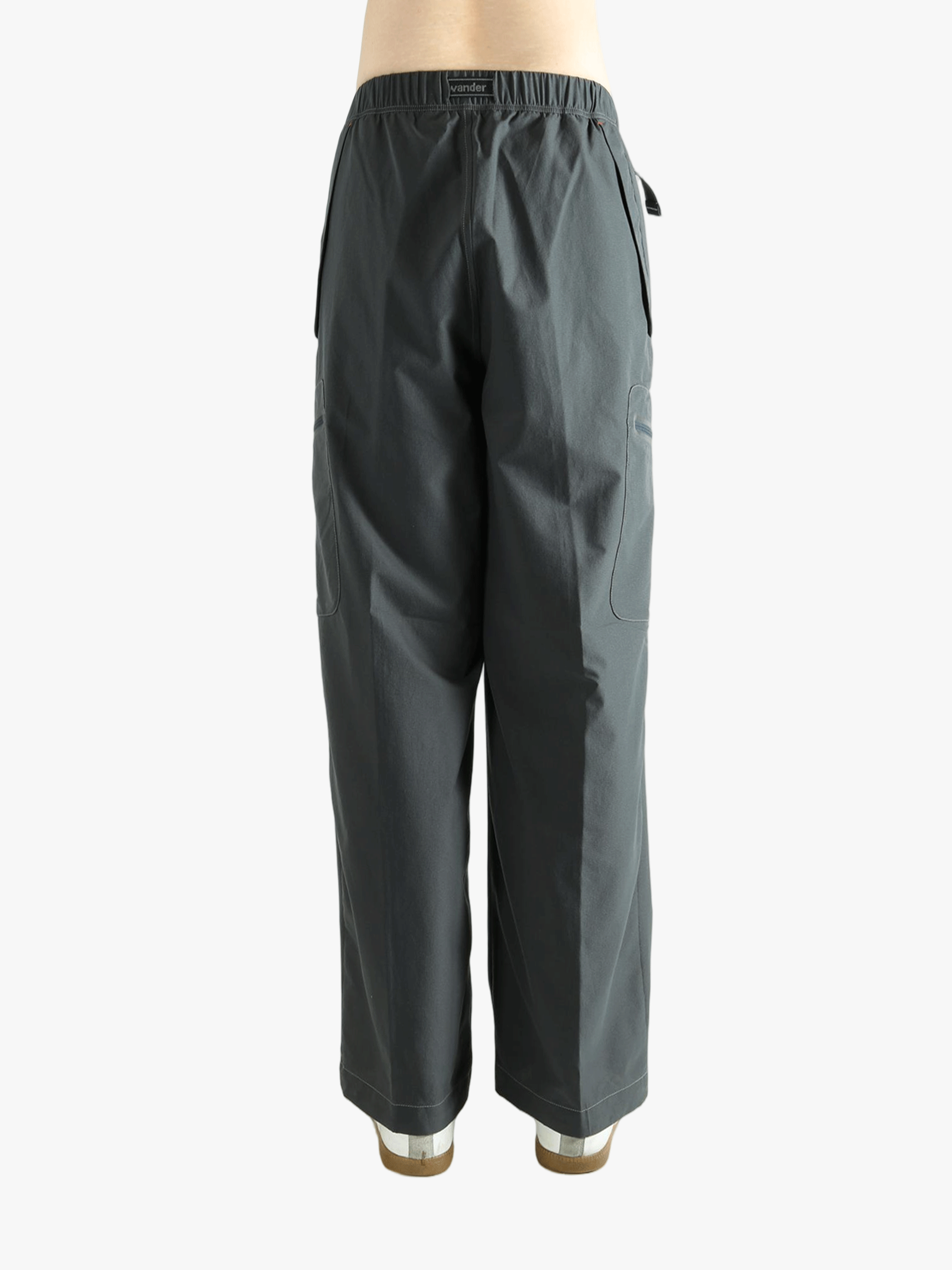 Black pants worn by a person, showing the pants's fit