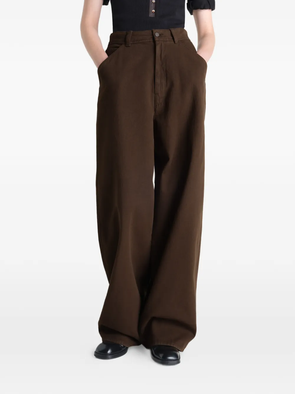 Brown pants worn by a person, showing the pants fit