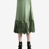 Green skirt worn by a person, showing the  skirt's fit