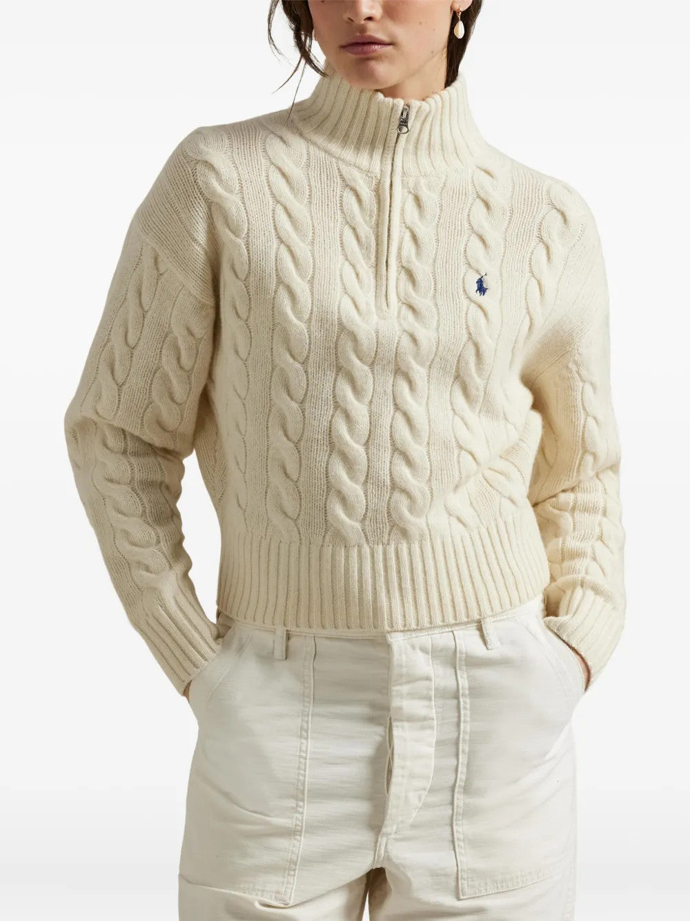 Tan knitwear worn by a person, showing the knitwear fit